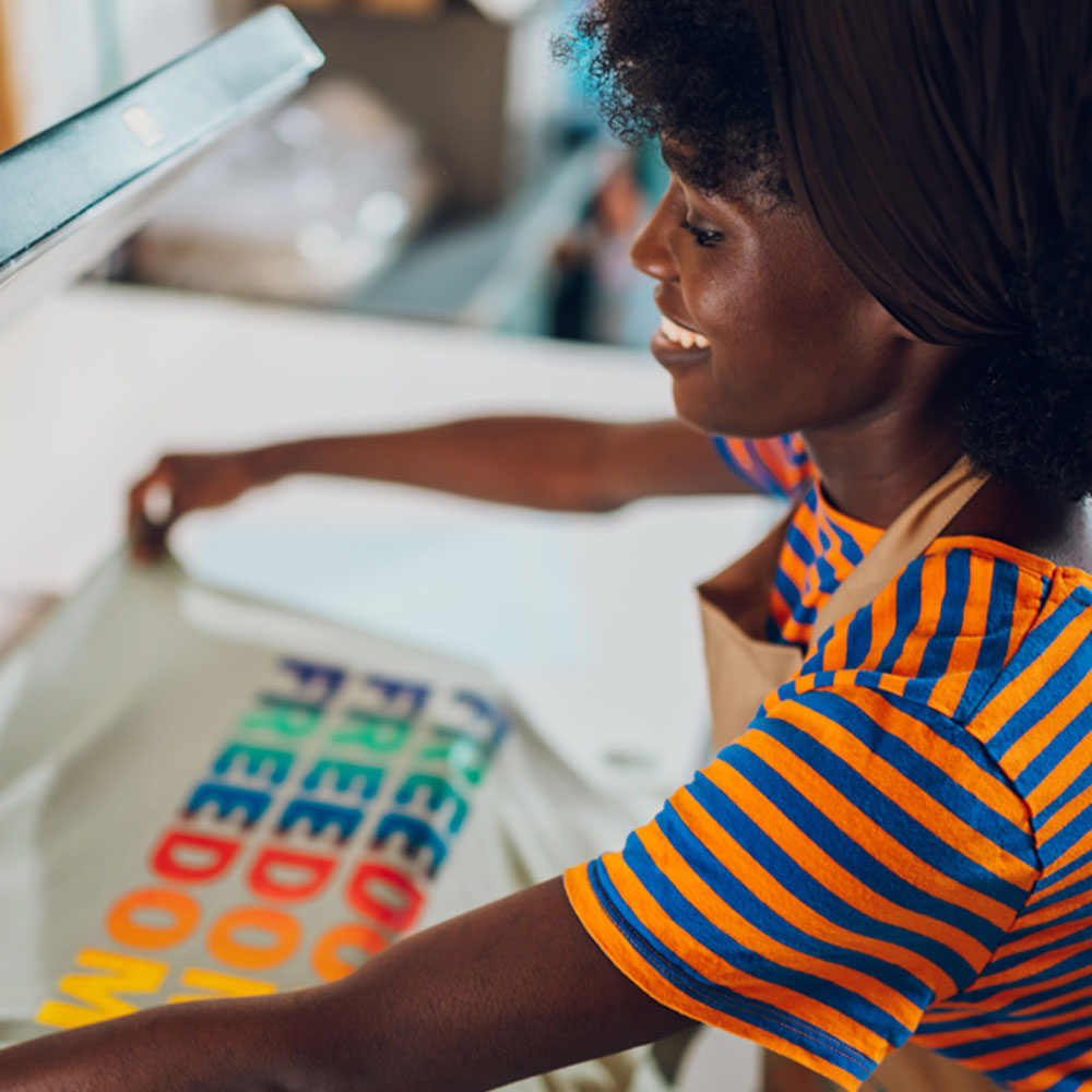 woman silkscreening a t-shirt